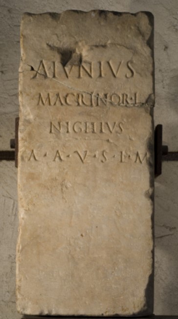 Quadrangular Sacred Stele (1st–2nd Century CE). Inscription: A(ulus) Iunius / Macrinor(um) l(ibertus) / Nigellus / A(quis) A(ponis) v(otum) s(olvit) l(ibens) m(erito)(Maffeian Lapidary Museum, Verona) - Aulus Iunius Nigellus, freedman of the Macrini, willingly and deservedly fulfilled his vow at Aquae Aponi (Abano Terme)